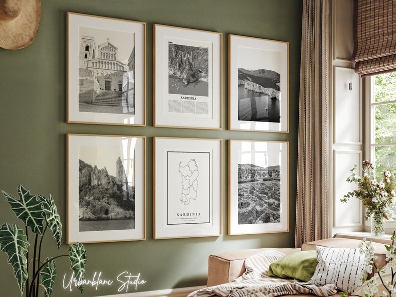 May include: A gallery wall of six black and white framed prints featuring various scenes from Sardinia, Italy. The prints include a cathedral, a coastline, a map of the island, and a rocky landscape.