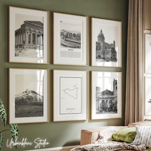 May include: A set of six black and white framed prints featuring images of various Sicilian landmarks, including a temple, a church, a mountain, and a map of the island. The frames are a light wood color and are arranged in a grid pattern on a green wall.