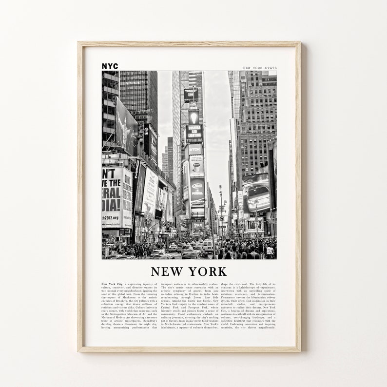 May include: Black and white framed print depicting Times Square, New York City. The image shows a bustling street scene with billboards, buildings, and traffic. The word "NEW YORK" is printed in large letters at the bottom.