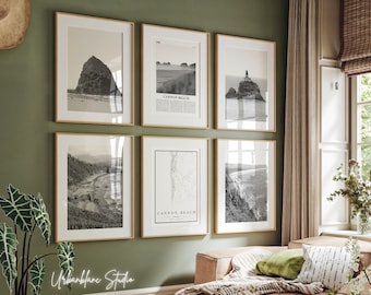 May include: A gallery wall of six black and white framed prints featuring coastal landscapes and a map of Cannon Beach, Oregon. The prints are arranged in a grid pattern on a sage green wall.