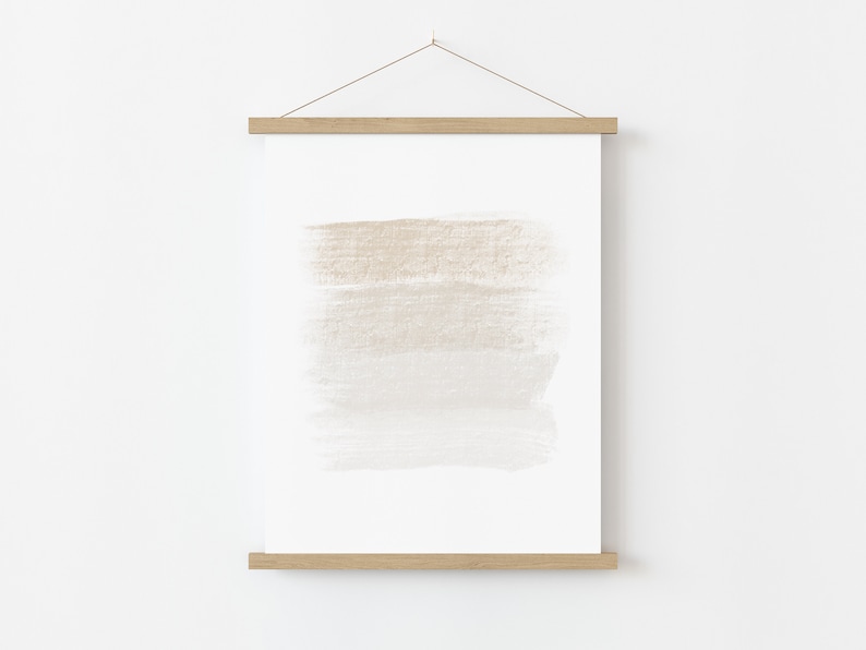 May include: A framed print with a beige and white abstract watercolor design. The print is hanging on a white wall.