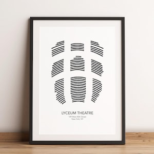 May include: A black and white print of the seating chart for the Lyceum Theatre in New York City. The print is framed in a black frame and is hanging on a white wall.