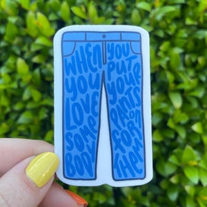 May include: A blue jean-shaped sticker with the text "When you put your pants on for the body you love" written on it.