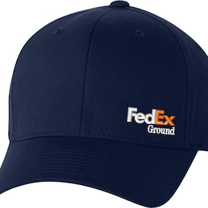 May include: A navy blue baseball cap with a white "FedEx Ground" logo embroidered on the front.