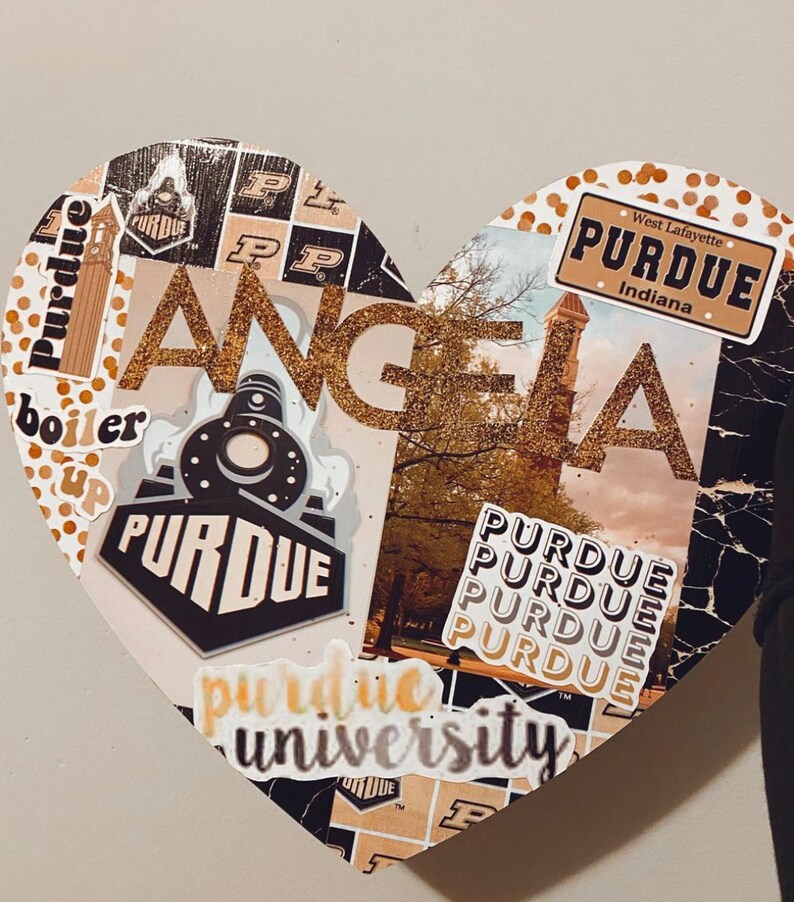 May include: A heart-shaped collage with a gold glitter background and various Purdue University stickers, including the school logo, the words "Purdue University", and "Boiler Up".