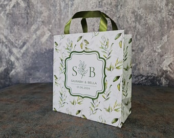 Welcome bags with greenery design and custom personalization. Hotel bags. More designs and ribbon colors available. Green leaves, wreath