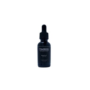 May include: A black glass bottle with a dropper top, labeled "TIMBERS" and "beard oil". The bottle is filled with a dark liquid.