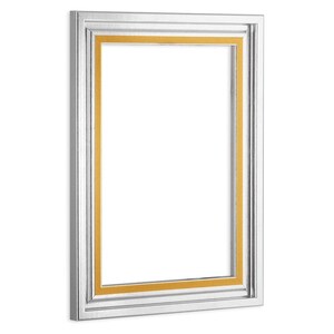 May include: A silver picture frame with a gold inner border. The frame has a simple, classic design.