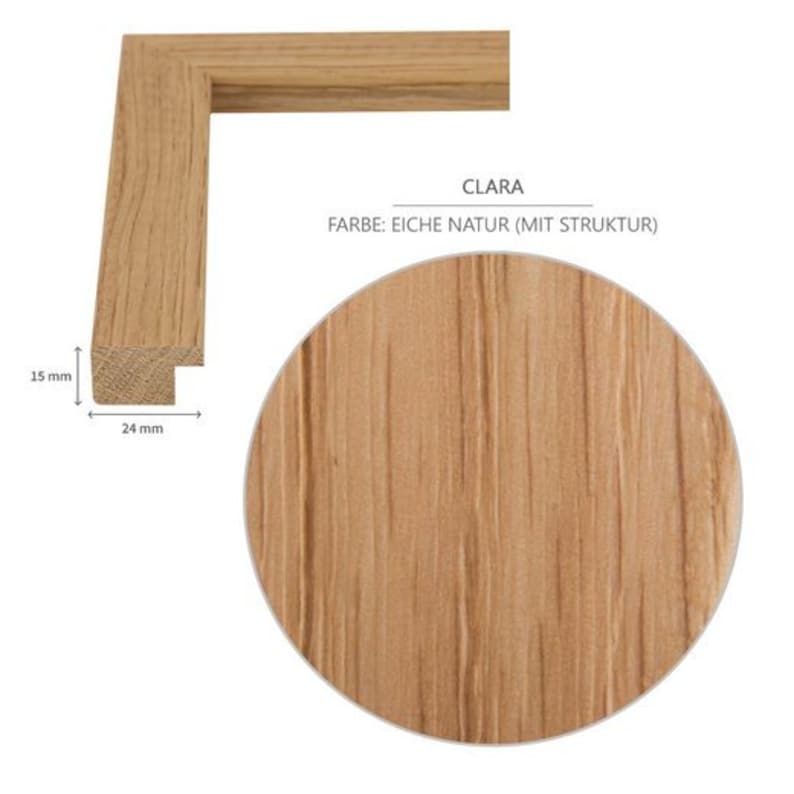May include: A wooden picture frame with a natural oak finish and a textured surface. The frame is 15 mm wide and 24 mm deep. The text "CLARA FARBE: EICHE NATUR (MIT STRUKTUR)" is printed on the frame.