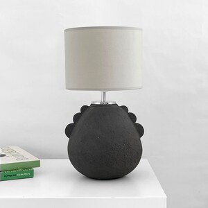 view of a model of a black lamp on a hall table.