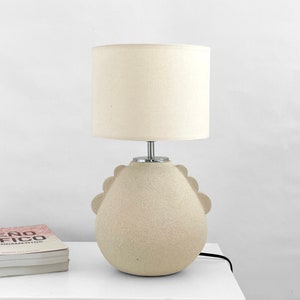 view of a model of a white cream colour lamp on a hall table.