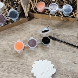 May include: A set of three ceramic mugs with a speckled, matte finish. The mugs are in shades of cream, light gray, and dark gray. Each mug has a simple, minimalist design, perfect for coffee or tea.
