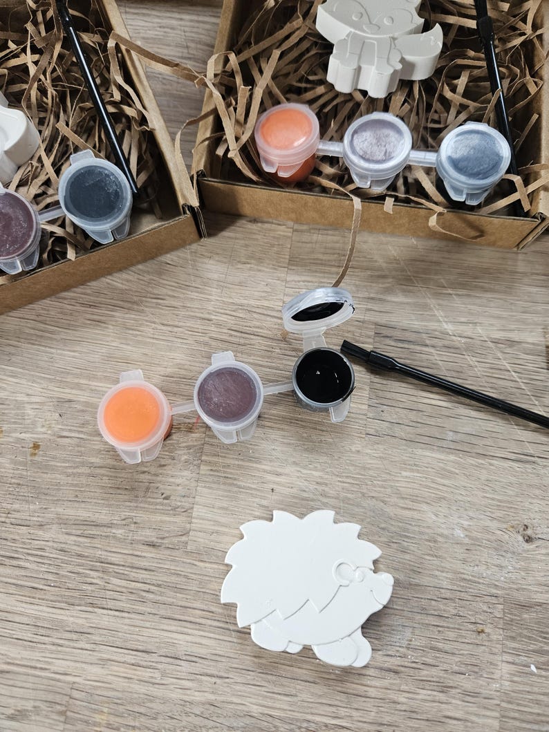 May include: A set of three ceramic mugs with a speckled, matte finish. The mugs are in shades of cream, light gray, and dark gray. Each mug has a simple, minimalist design, perfect for coffee or tea.