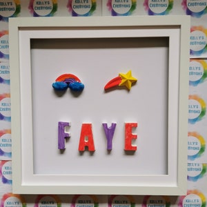May include: A white picture frame with a white mat and a white background. The name "FAYE" is spelled out in colorful 3D letters. There is a rainbow and a shooting star above the name.