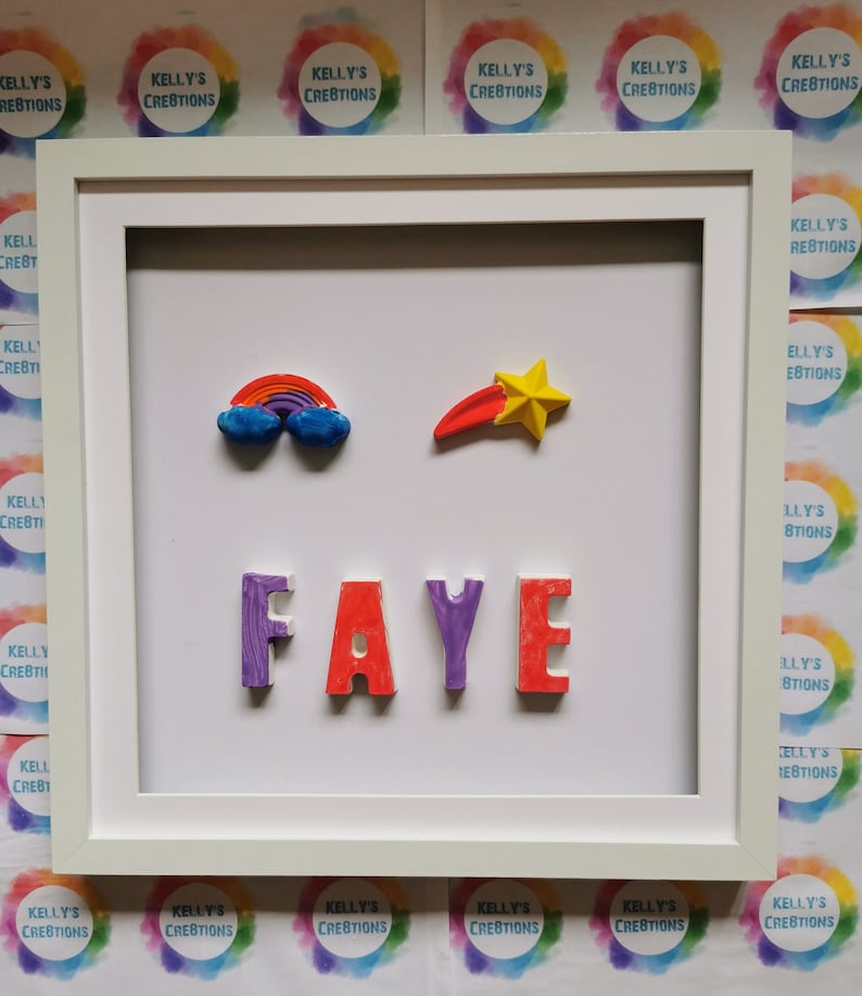 May include: A white picture frame with a white mat and a white background. The name "FAYE" is spelled out in colorful 3D letters. There is a rainbow and a shooting star above the name.