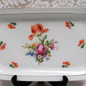 May include: White rectangular serving tray with a gold trim and a floral design featuring a pink rose, orange tulips, and other flowers in shades of yellow, blue, and green.