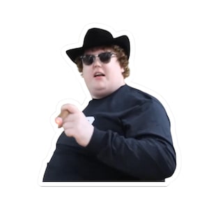 May include: A sticker featuring a person wearing a black cowboy hat, sunglasses, and a black long-sleeve shirt. The person is holding a lit cigar and pointing. The sticker has a white border.