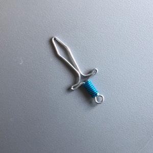 Sword craft made from galvanized steel wire. It can be used as ornament, necklace pedant, earring, key chain item, etc.