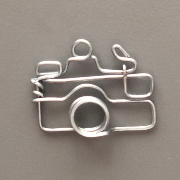 Camera craft made from galvanized steel wire. It can be used as bookmark, ornament, necklace pedant, earring, key chain item, etc.