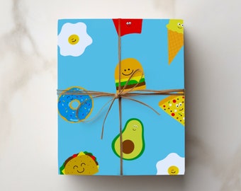 May include: Blue wrapping paper with a pattern of various foods with happy faces, including a doughnut, avocado, taco, burger, pizza, and eggs. The paper is tied with brown twine.