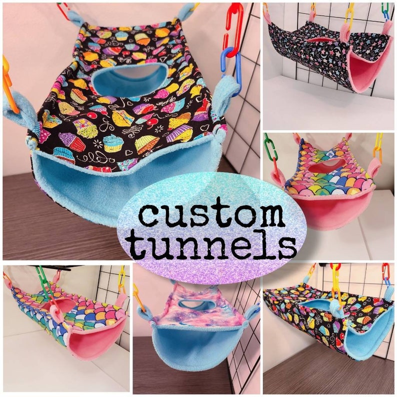 May include: A collection of custom tunnels for small pets, featuring various colorful patterns. Designs include cupcakes, celestial themes, and mermaid scales. Each tunnel has a soft, plush interior and is suspended by chains.