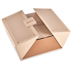 May include: A beige box with a geometric pattern and a gold logo that says "NAYCE". The box is open and the inside is a light brown color.