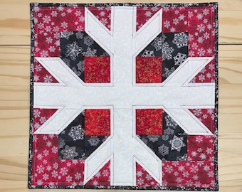 White snowflake with red & black accents, Handmade quilted table topper, Winter snowflake table quilt