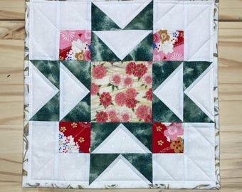 Double star quilted table topper, Green star with red & pink floral fabrics, 12x12” star table quilt