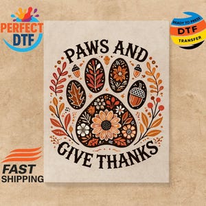May include: A beige graphic featuring a paw print design with the words "Paws and Give Thanks." The paw print is filled with floral and leaf patterns in shades of orange, brown, and cream. Acorns and leaves surround the paw print.