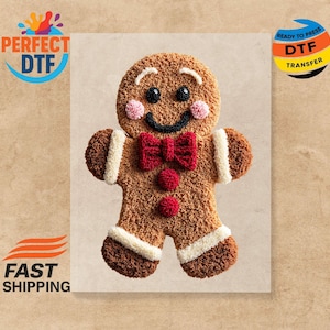 Puede incluir: Una transferencia de hombre de jengibre con una cara sonriente, una pajarita roja y mejillas rosadas. La transferencia está lista para planchar y presenta el texto "PERFECT DTF" y "READY TO PRESS DTF TRANSFER".