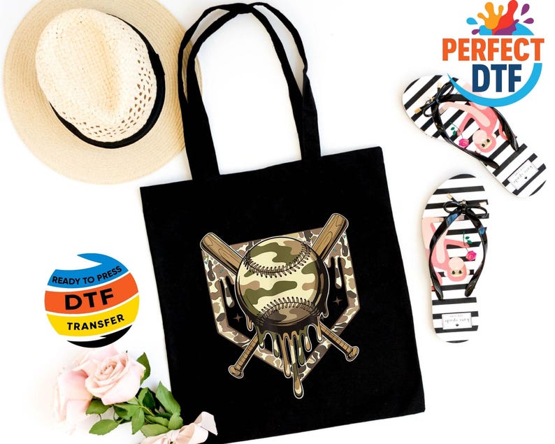 May include: Black tote bag with a baseball design featuring a camouflage pattern and dripping effect. The image includes a straw hat, black and white striped flip-flops with flamingo graphics, and DTF transfer stickers.