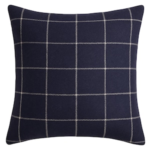 May include: Square navy blue decorative pillow with a grid pattern in a lighter beige color. The pillow has a soft, textured appearance and is likely made of fabric. The grid pattern is evenly spaced across the pillow's surface.