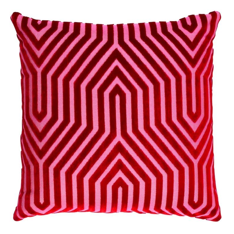May include: A pink and red geometric patterned throw pillow with a velvet texture.