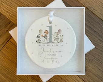 Może przedstawiać: Biała ceramiczna ozdoba z szarym numerem jeden, lisem, szop praczem, słoniem i królikiem. Ozdoba zawiera napis "Happy First Birthday Jackson 31.08.2023 Love from Auntie Becky".