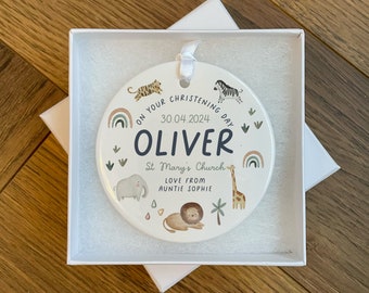 May include: A white ceramic round ornament with a colorful rainbow design and animal illustrations. The text reads "On your christening day 30.04.2024 Oliver St Mary's Church Love from Auntie Sophie".