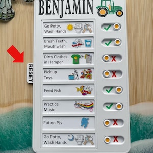 May include: White chore chart for Benjamin with a green tractor graphic. The chart includes illustrated tasks like brushing teeth and washing hands, with check boxes for completion. A small "RESET" tab is on the side.