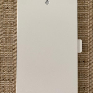 May include: A rectangular, off-white metal sign with rounded corners. It features a small, circular hole at the top for hanging and a rectangular tab on the right side. The sign has a textured surface.