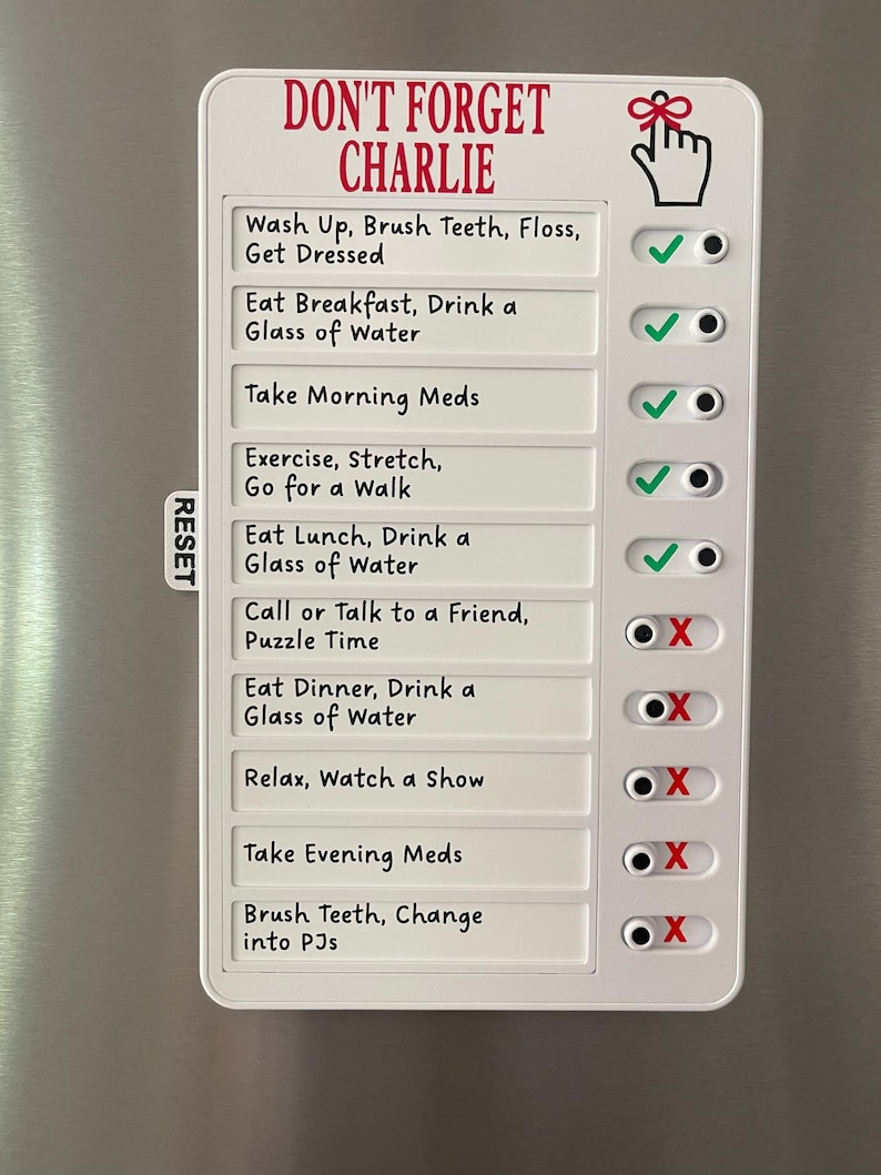 May include: A white magnetic chore chart with the text "DON'T FORGET CHARLIE" in red. The chart includes a list of daily tasks with check boxes. The tasks include "Wash Up, Brush Teeth, Floss, Get Dressed" and "Eat Breakfast, Drink a Glass of Water."