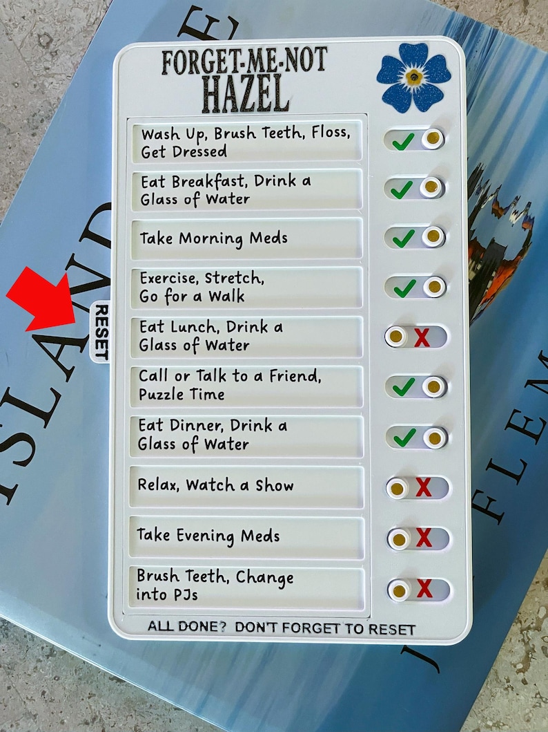 May include: A white daily routine checklist with the text "FORGET-ME-NOT HAZEL". The checklist includes tasks like "Wash Up, Brush Teeth, Floss, Get Dressed" and "Eat Breakfast, Drink a Glass of Water". It has a blue flower graphic.