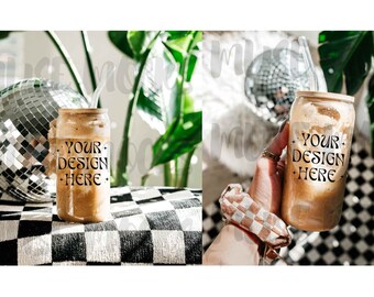 May include: Two images of a brown iced coffee drink in a clear glass with a straw. The glass has the text "YOUR DESIGN HERE" printed on it. The first image shows the glass on a black and white checkered surface. The second image shows a hand holding the glass.