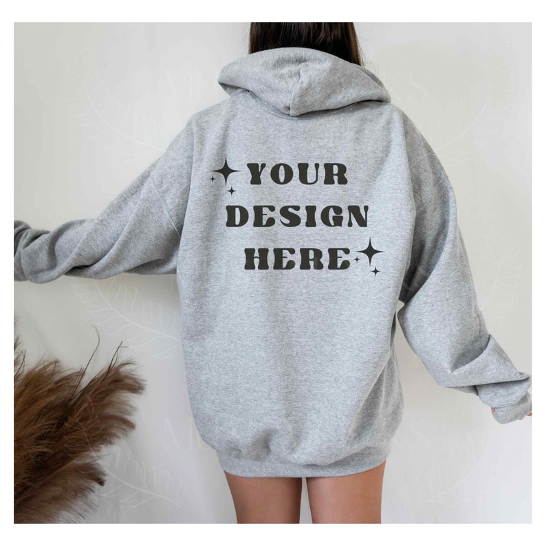May include: Gray hooded sweatshirt with the text "YOUR DESIGN HERE" printed on the back.