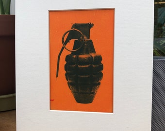 Cyanotype of an hand grenade on a orange background