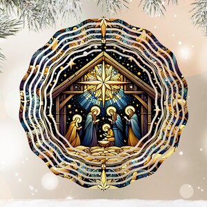 May include: A layered, circular Christmas ornament featuring a Nativity scene. The artwork depicts the Holy Family and the Three Wise Men in a stable, with a star overhead. The color palette includes blues, golds, and browns.