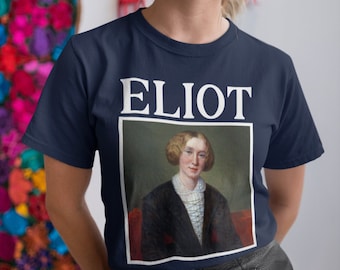 May include: A navy blue t-shirt with a white print of the word "ELIOT" and a portrait of a woman in a black dress with a white collar.