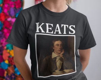 May include: A black t-shirt with a white graphic of a portrait of John Keats and the word "KEATS" above the portrait.