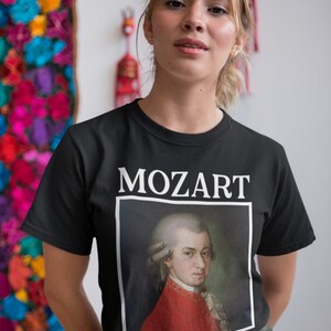 May include: A black t-shirt with a white print of Mozart's portrait and the word "MOZART" above it.