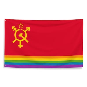 May include: A red flag with a yellow hammer and sickle symbol and a yellow star. The symbol is surrounded by a circle with two yellow arrows pointing outwards. The flag has a rainbow stripe at the bottom.