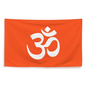 May include: Orange flag featuring a large, white Om symbol. The Om symbol is a sacred sound and spiritual icon in Hinduism, Buddhism, and Jainism. The flag has grommets for hanging.
