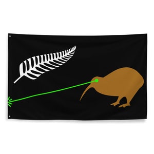 May include: Black flag with a brown kiwi bird and a green laser beam from its eye. A white fern leaf is in the upper left corner. The flag has eyelets for hanging. The design is a humorous take on a national symbol.