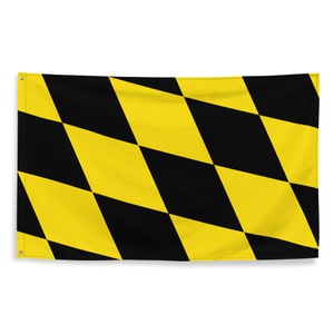 May include: A yellow and black checkered flag. The flag is made of fabric and has a diamond pattern.